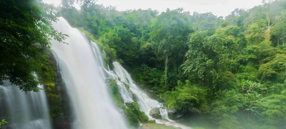 A waterfall with trees in the background