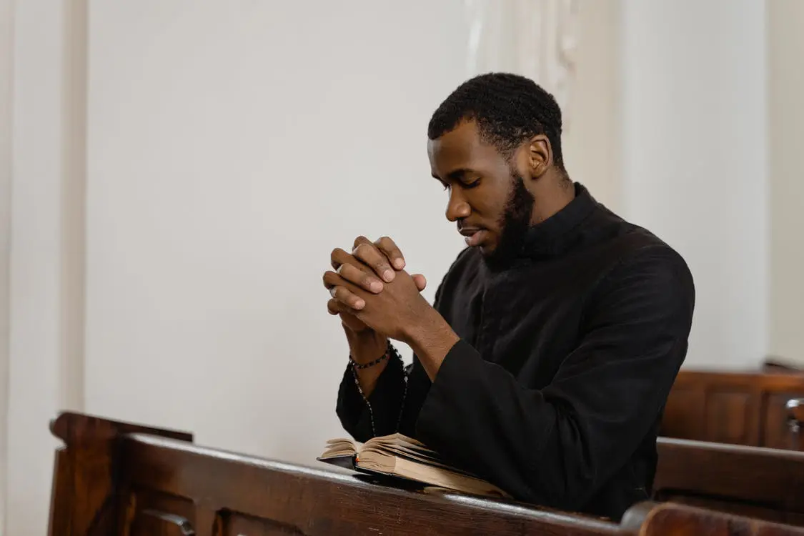 A man sitting in front of an open bible.