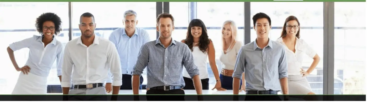 A group of people standing around a table.